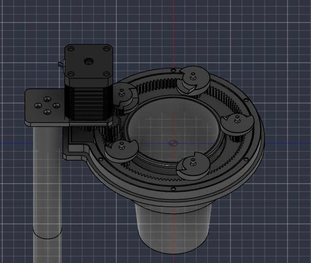 Nhìn từ trên xuống: motor bước, bánh răng nhỏ ăn vào vành răng trong, năm ngàm quanh miệng ống